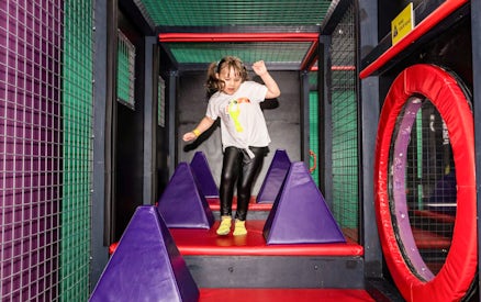 Child navigating obstacle course at SuperPark Malaysia.