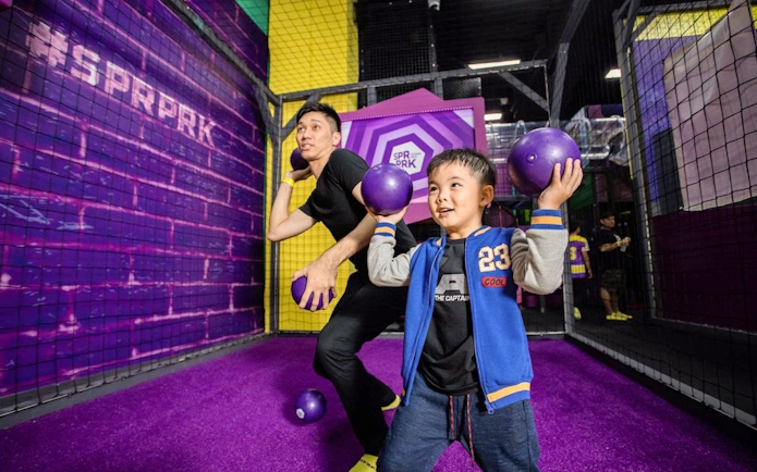 Father and son playing with balls at Superpark, Malaysia.