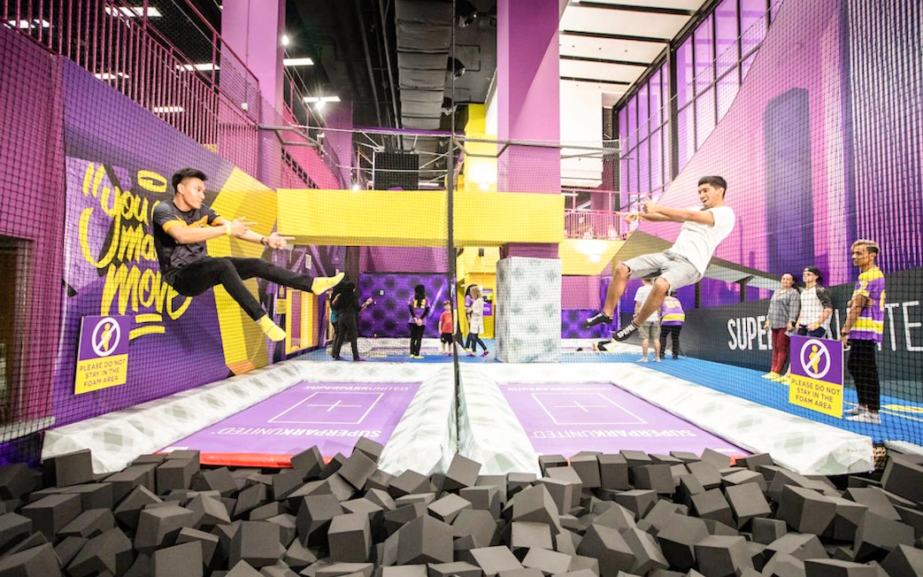 Men jumping on trampolines at SuperPark, Malaysia.