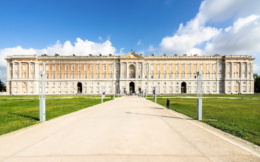 Royal Palace of Caserta facade with pathway, Naples tour destination.