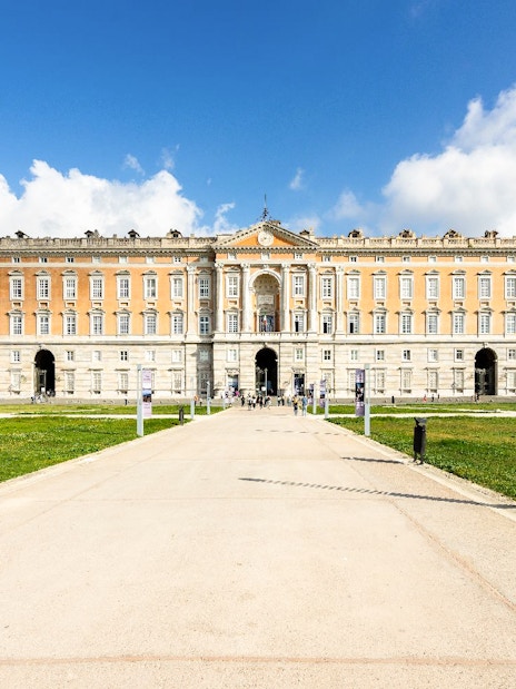Royal Palace of Caserta facade with pathway, Naples tour destination.
