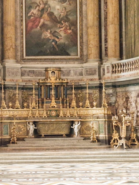 Royal Palace of Caserta ornate interior with gilded altar and marble columns.