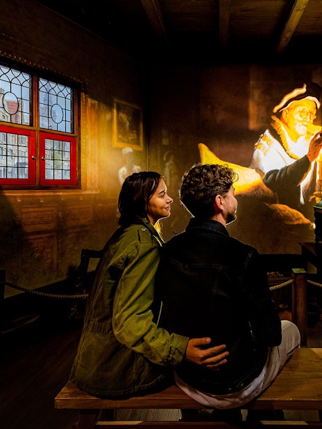 Tourists watching Rembrandt projection at Rembrandts Amsterdam Experience.