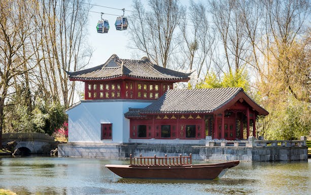 Visitors exploring themed landscapes in Berlin's Gardens of the World during a guided tour.