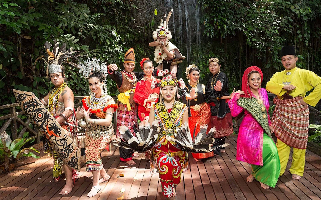 Traditional dancers in colorful attire at Sarawak Cultural Village, showcasing cultural heritage.
