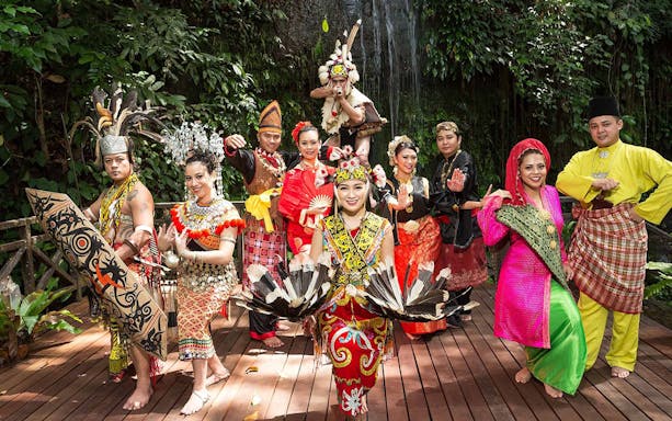 Traditional dancers in colorful attire at Sarawak Cultural Village, showcasing cultural heritage.