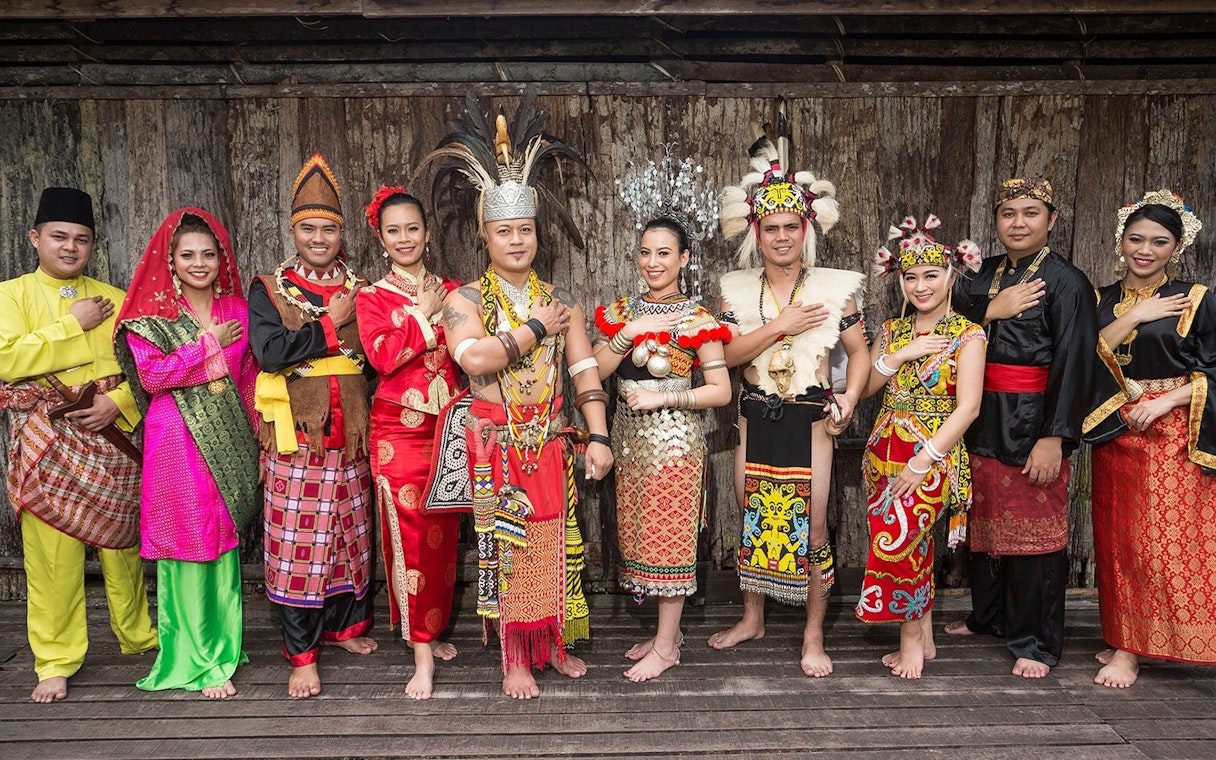 Traditional dancers in colorful attire at Sarawak Cultural Village, Malaysia.