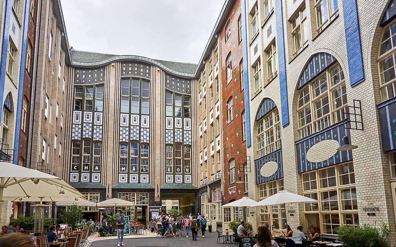 Guided tour group exploring Hackesche Höfe courtyard in Berlin's Scheunenviertel.