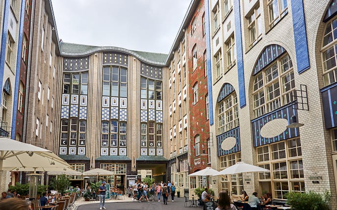 Guided tour group exploring Hackesche Höfe courtyard in Berlin's Scheunenviertel.