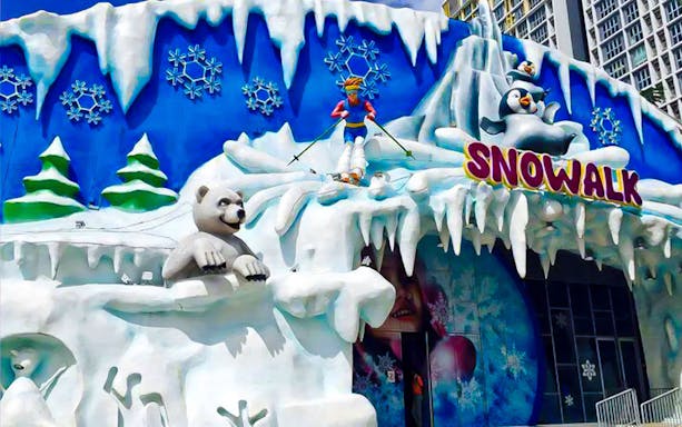 Snow-themed entrance at I-City Theme Park with polar bear and penguin sculptures.
