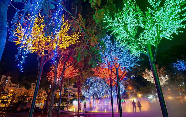 Colorful LED-lit trees at night in I-City Theme Park, Malaysia.