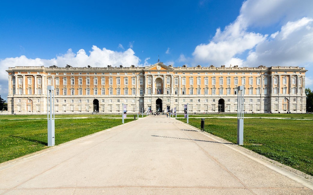 Royal Palace of Caserta, Italy, with grand facade and expansive gardens.