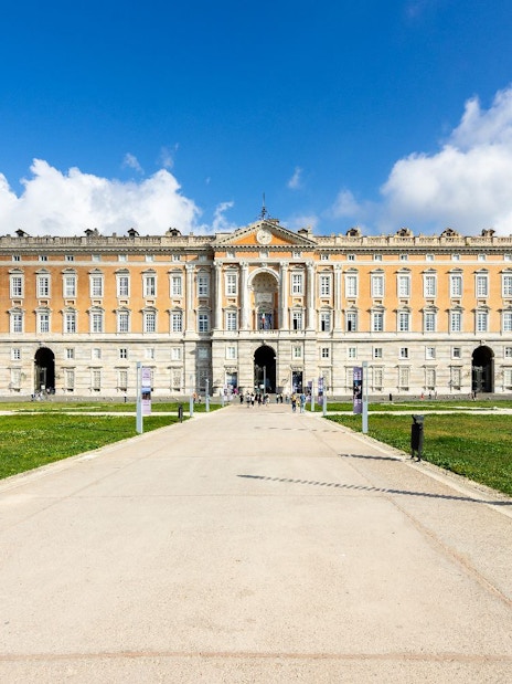 Royal Palace of Caserta, Italy, with grand facade and expansive gardens.