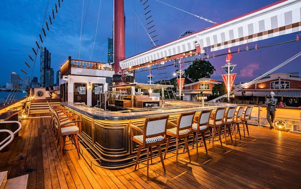 Sirimahannop Dinner Cruise deck at Asiatique The Riverfront, Bangkok, with bar seating.