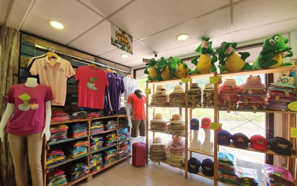 Crocodile Adventureland Langkawi gift shop with crocodile-themed shirts and plush toys.