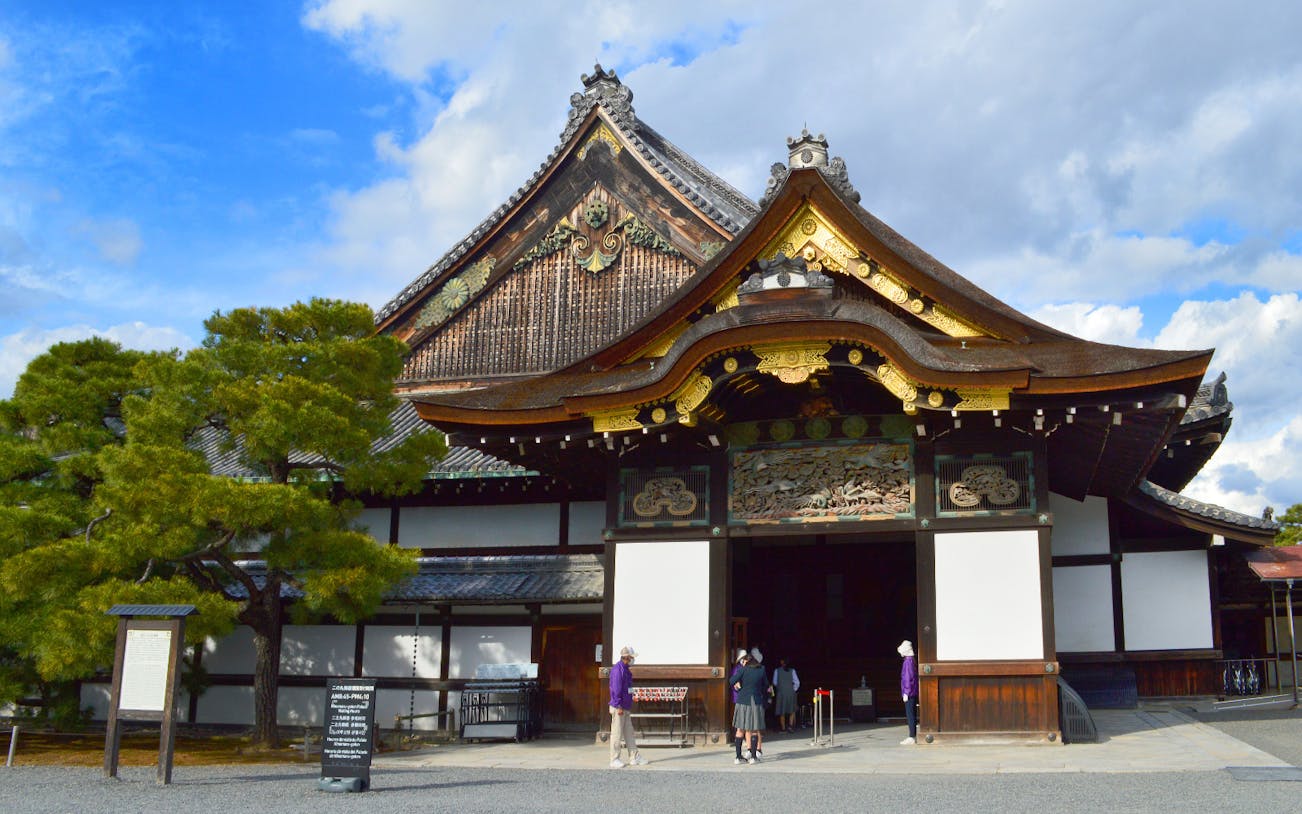 Nijo Castle entrance with ornate wooden architecture in Kyoto, Japan.