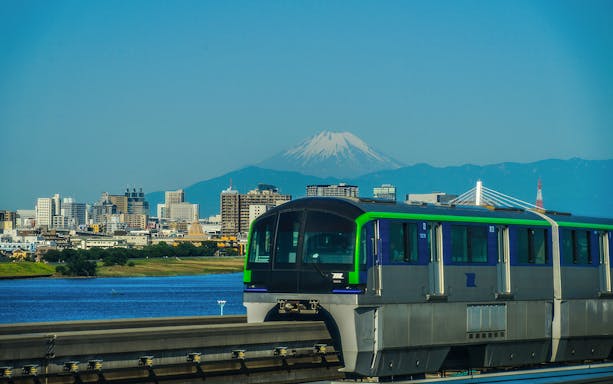 Monorail traveling from Haneda Airport to Tokyo with Mount Fuji in the background.
