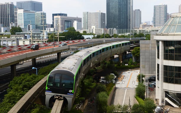 Monorail traveling through Tokyo cityscape near Haneda Airport.