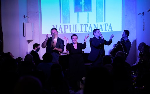Traditional Neapolitan music concert with performers on stage in Naples, Italy.