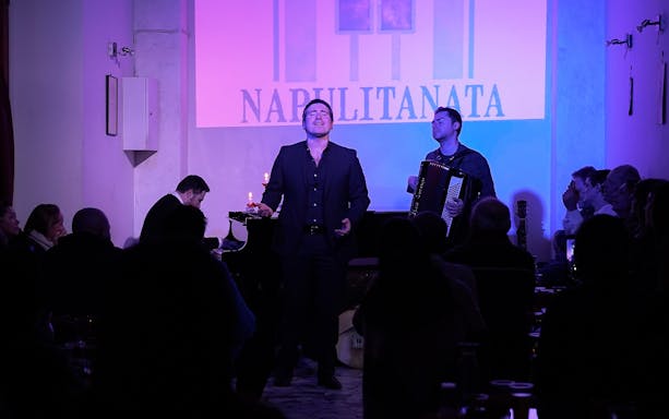 Singer and accordionist performing at a traditional Neapolitan music concert in Naples.