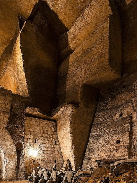 Bourbon Tunnel interior with vintage cars and stone arches, Naples guided tour.