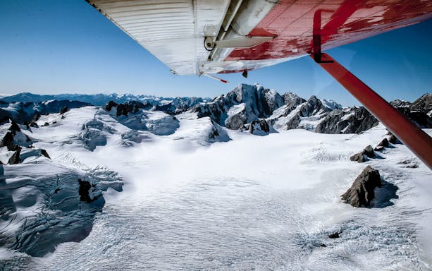 Skiplane view over snow-covered alpine mountains during Ultimate Alpine Experience.