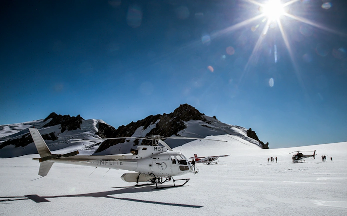 Helicopter and ski plane on snowy Southern Alps during 1-hour aerial tour.