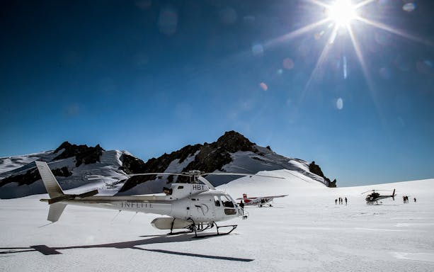 Helicopter and ski plane on snowy Southern Alps during 1-hour aerial tour.