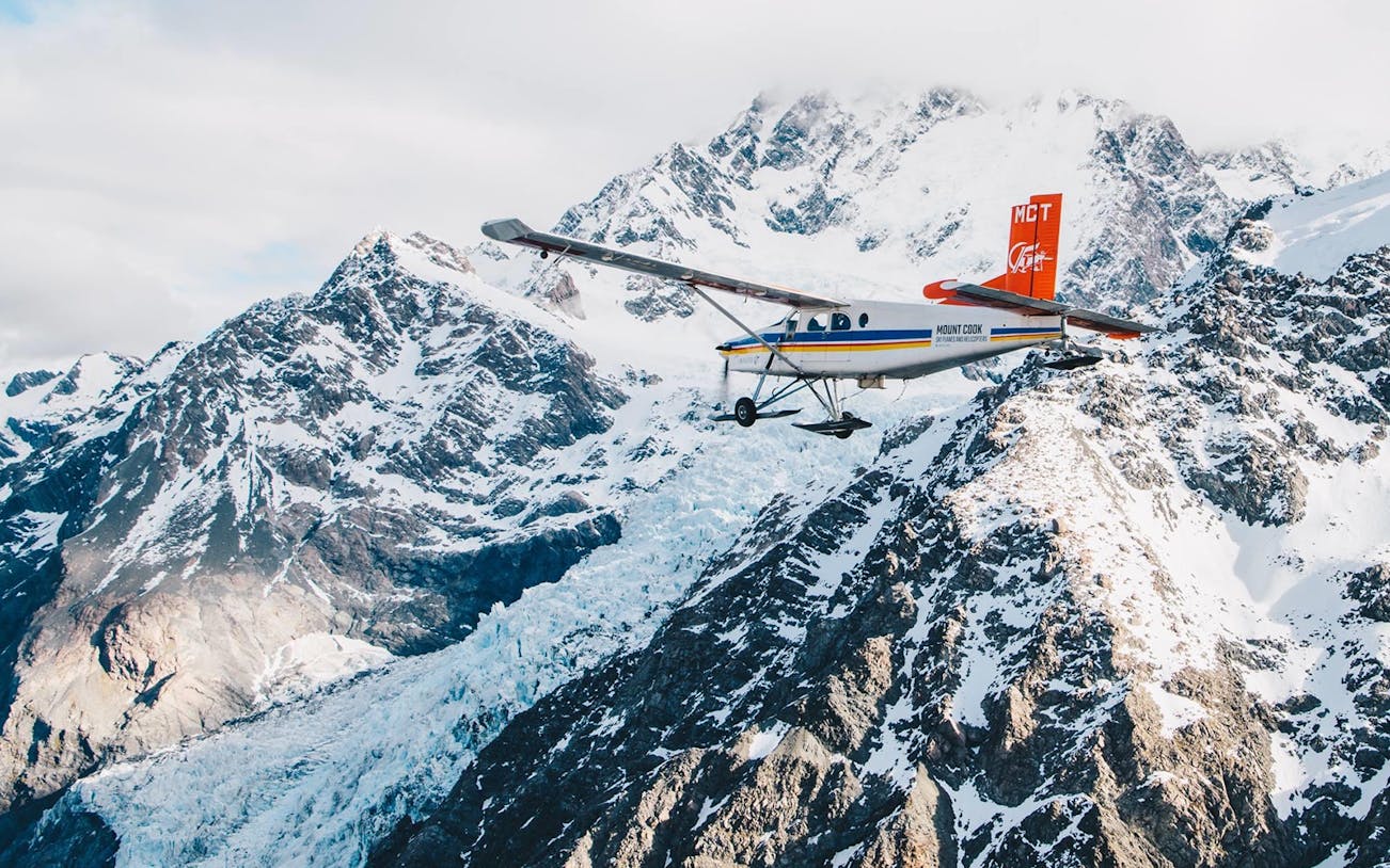 Helicopter flying over snow-covered mountains during a 45-minute glacier tour.