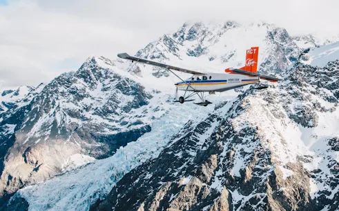 Helicopter flying over snow-covered mountains during a 45-minute glacier tour.