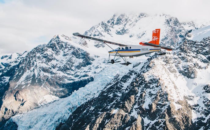 Helicopter flying over snow-covered mountains during a 45-minute glacier tour.