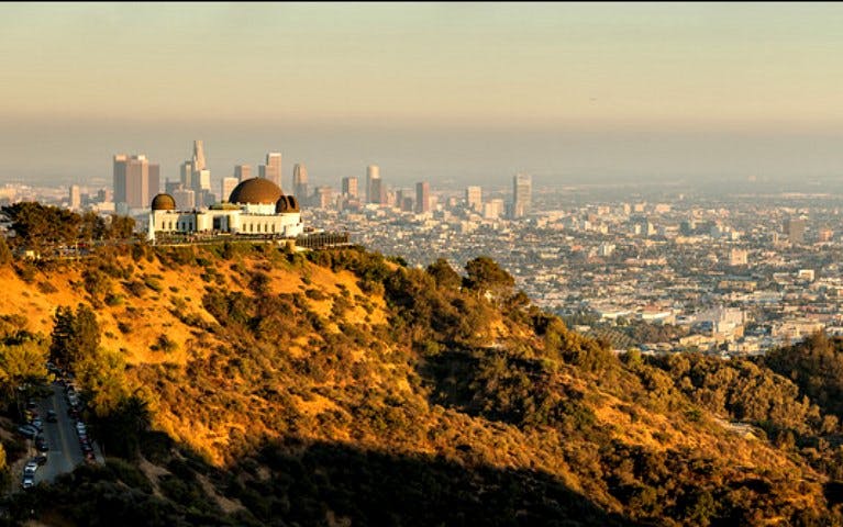 Griffith Observatory overlooking Los Angeles skyline during Hollywood Hills hike.