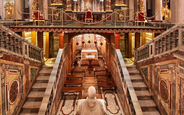 Interior view of Santa Maria Maggiore Basilica altar and ornate architecture.
