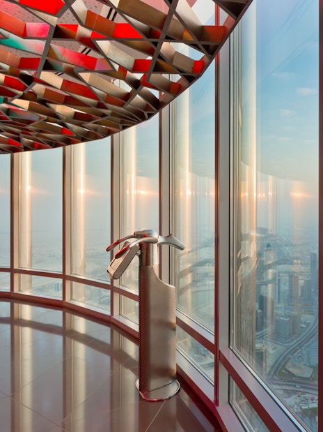 Burj Khalifa observation deck view of Dubai skyline at sunset.