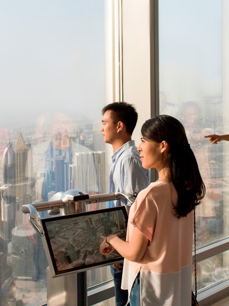 Visitors enjoying the view from Burj Khalifa observation deck in Dubai.