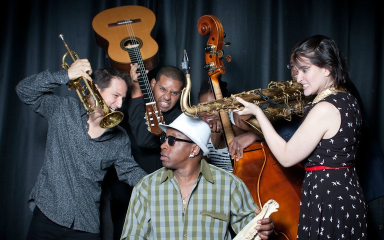 Musicians from the Gabriel Alegría Afro-Peruvian Sextet playing instruments.