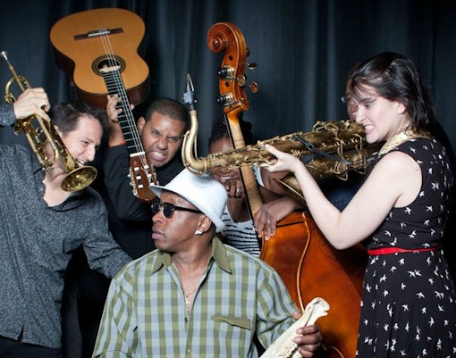 Musicians from the Gabriel Alegría Afro-Peruvian Sextet playing instruments.