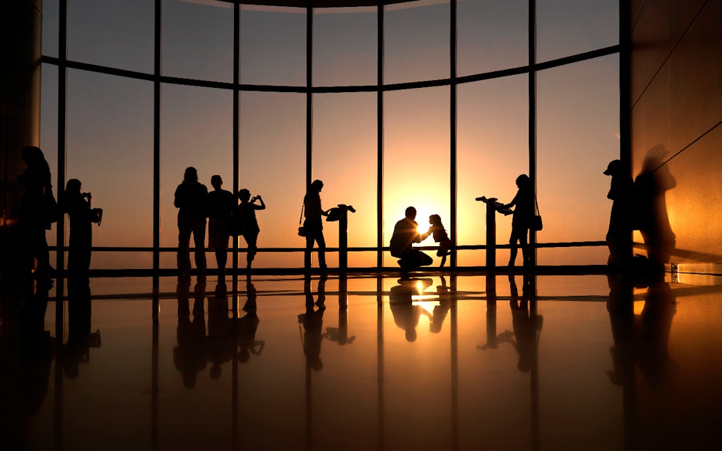 Visitors enjoying sunset views from Burj Khalifa's Level 124 and 125 observation deck.