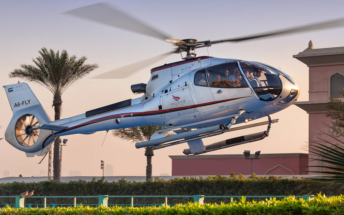 Luxury helicopter flying over Dubai landscape during 15-minute tour.