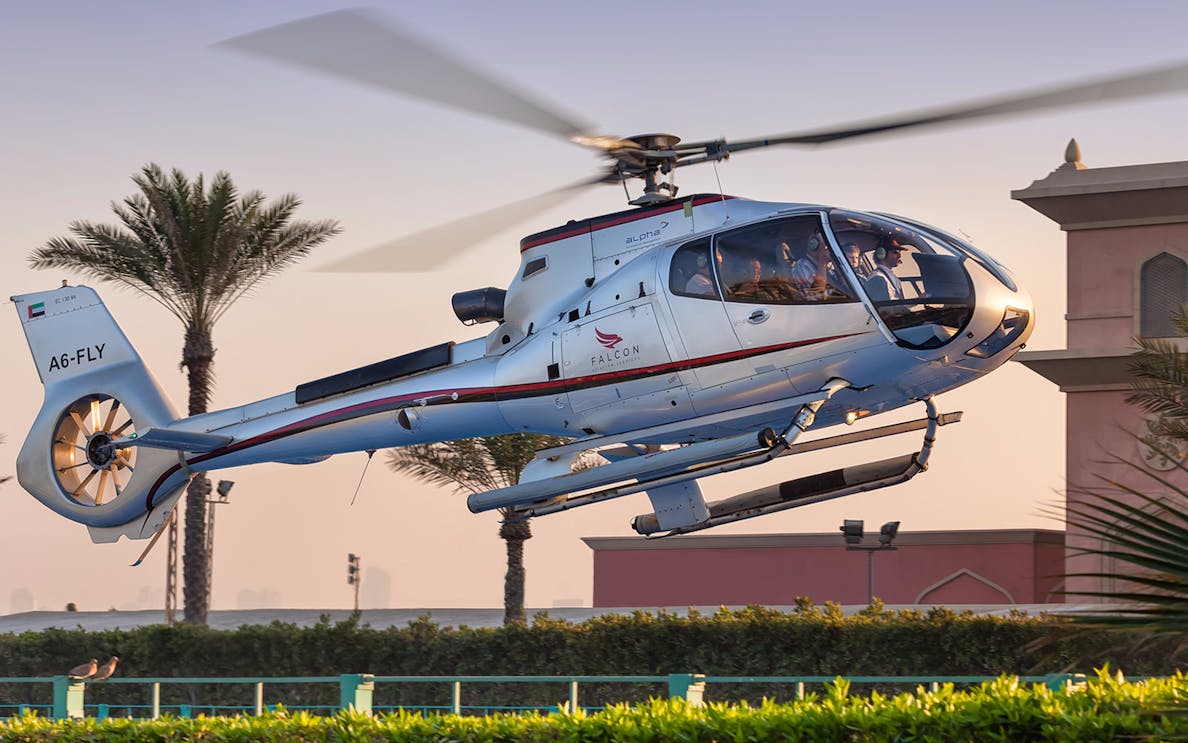Luxury helicopter flying over Dubai landscape during 15-minute tour.