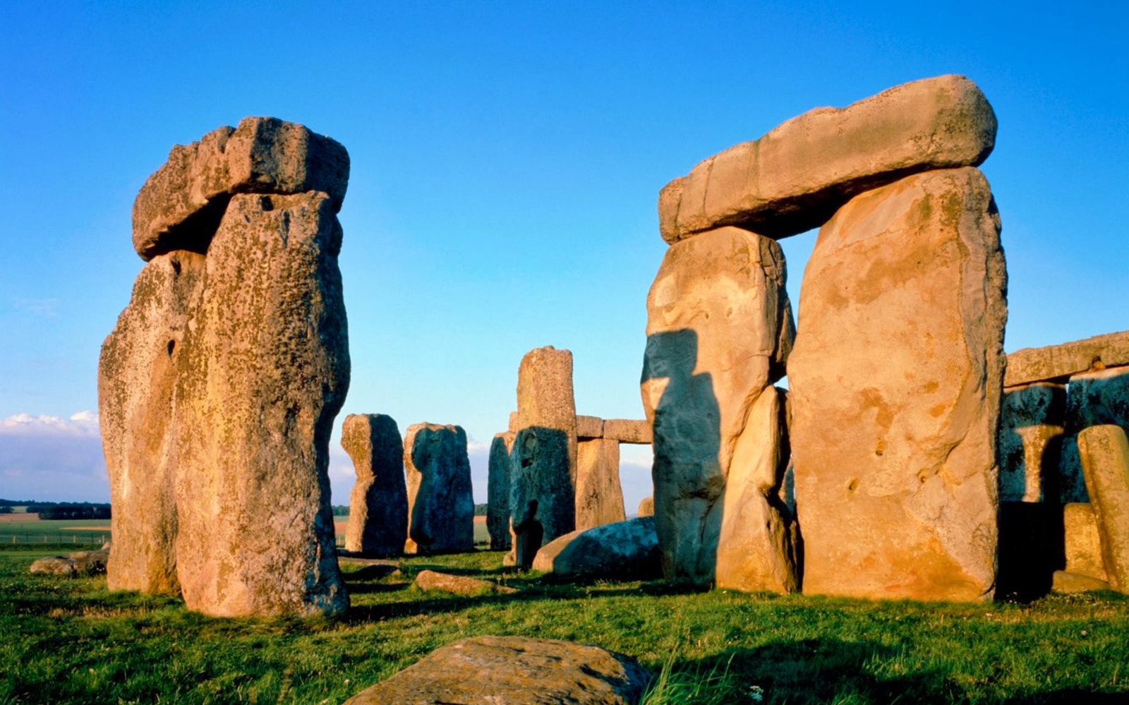 Stonehenge at sunset in Wiltshire, England, showcasing ancient stone circle.