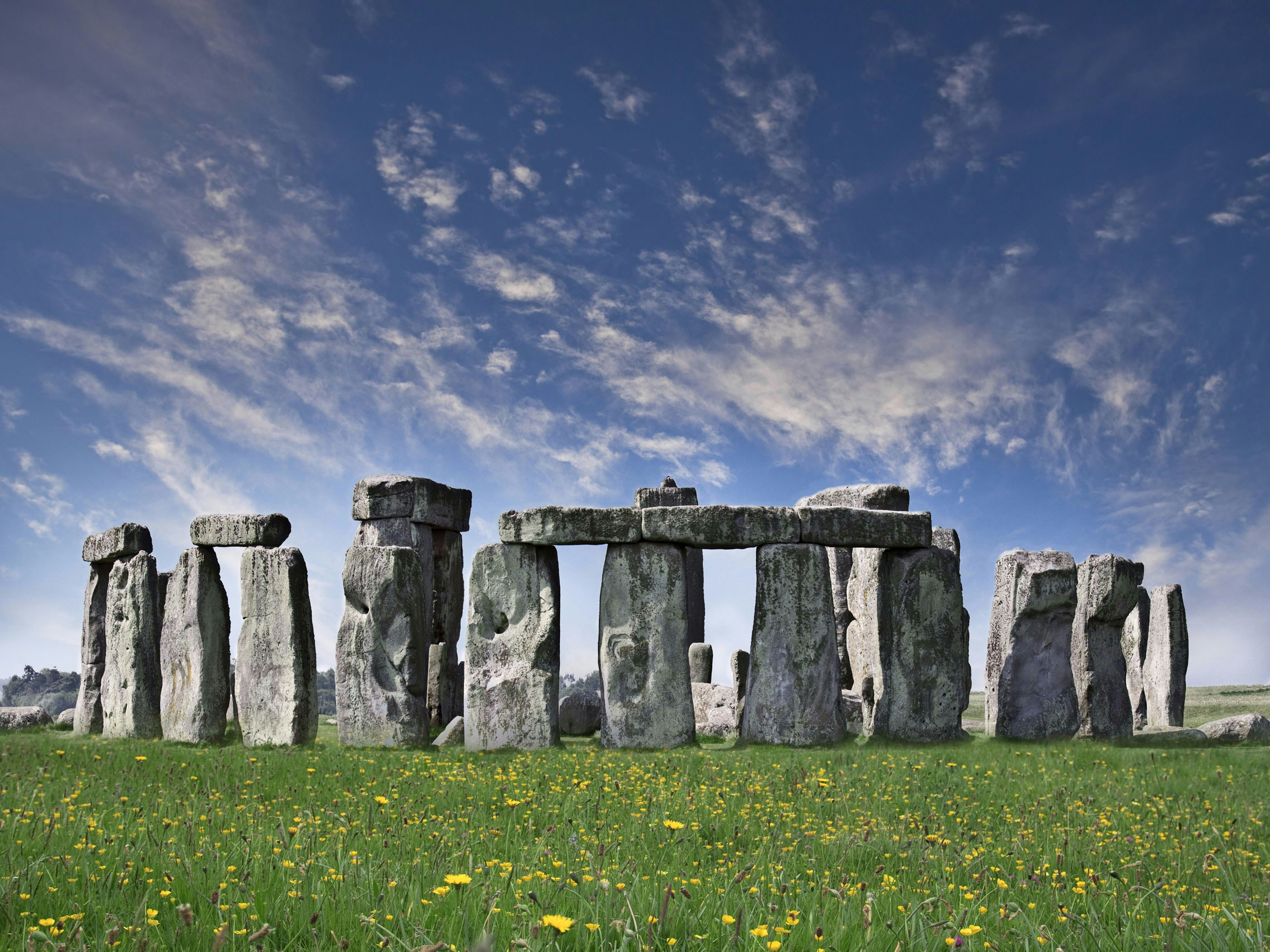 Stonehenge stone circle under a blue sky, part of Windsor Castle, Stonehenge, and Bath tour from London.