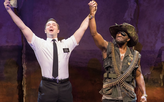 Actors performing in "The Book of Mormon" musical scene.