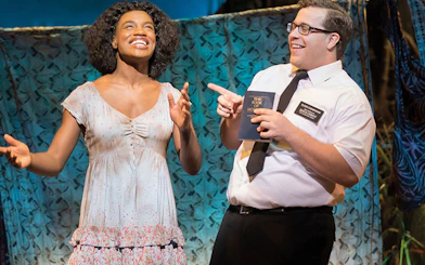 Actors performing a scene from The Book of Mormon musical.