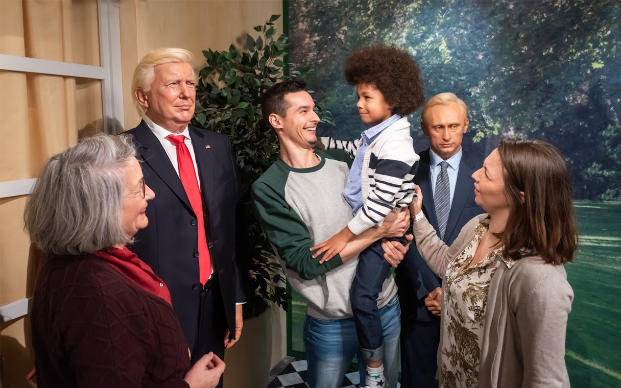 Family interacting with wax figures at Grévin Paris Wax Museum.