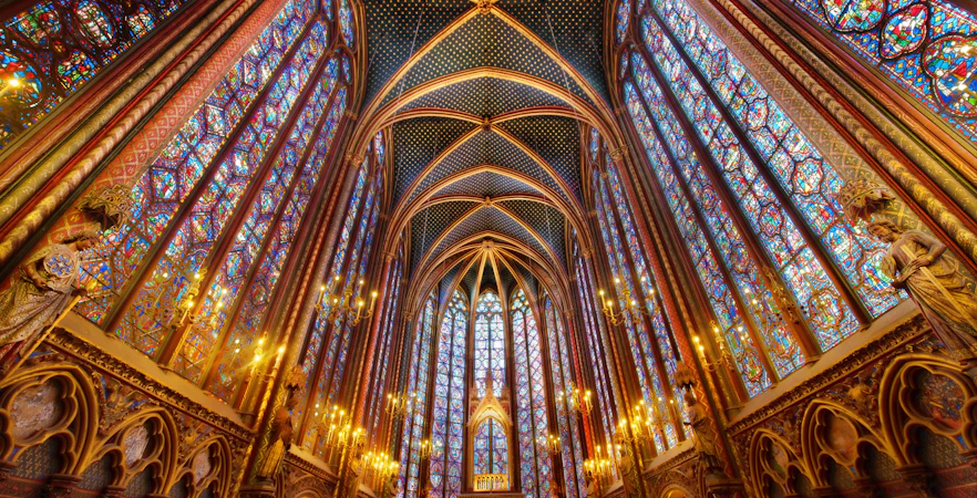 Notre Dame Cathedral facade with tourists on a guided tour in Paris, France.