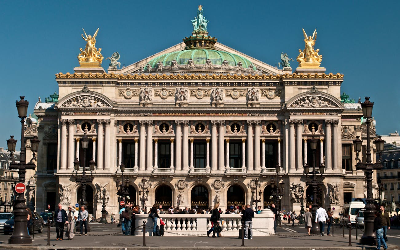 Opera Garnier facade with visitors in Paris, France.