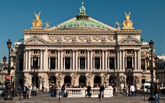 Opera Garnier facade with visitors in Paris, France.