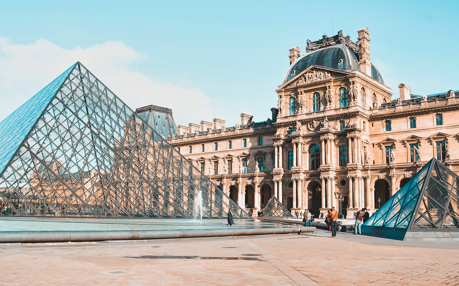 Louvre Museum glass pyramid entrance in Paris, France.
