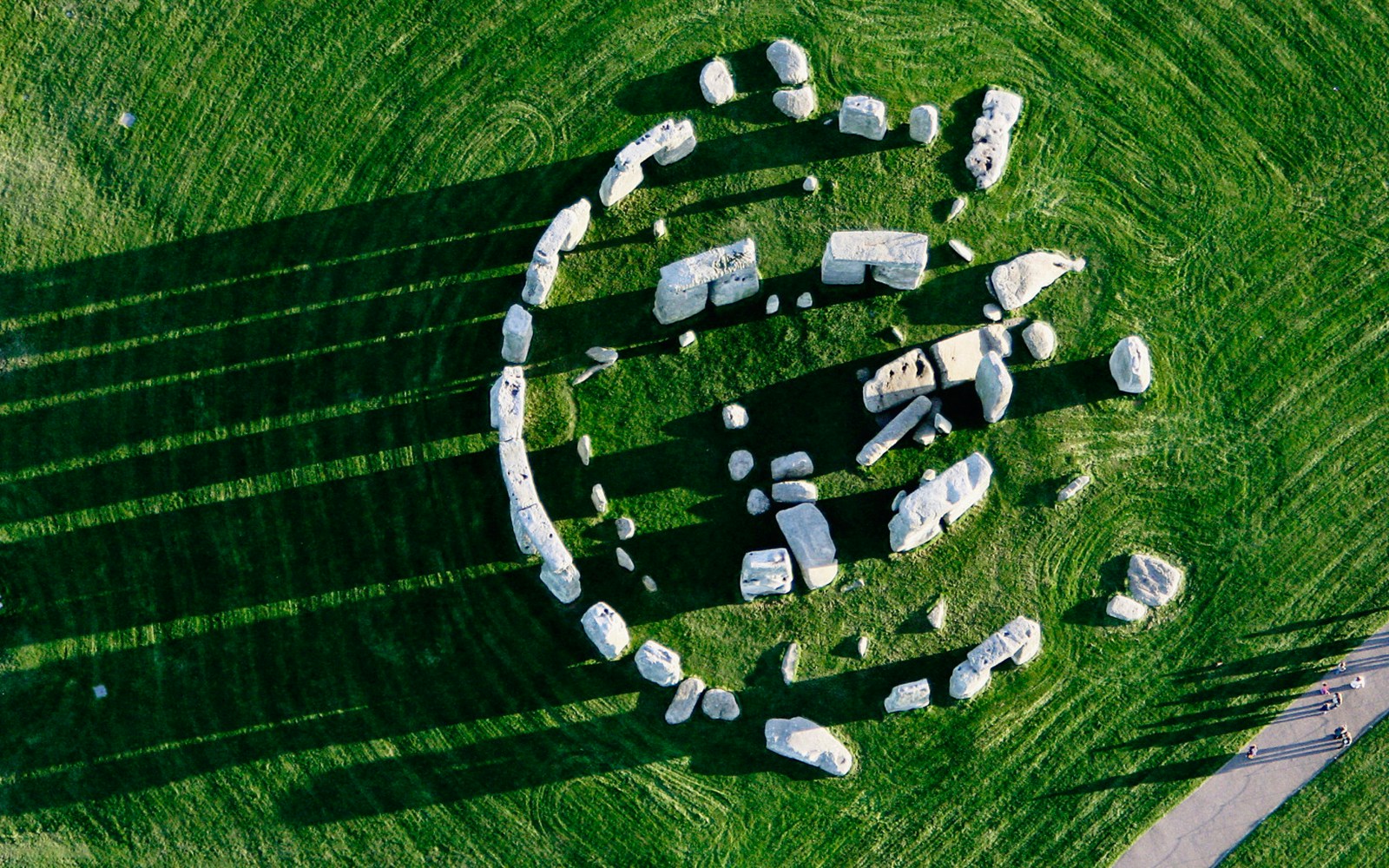 Aerial view of Stonehenge stone circle on green grass, part of Salisbury and Avebury tour.
